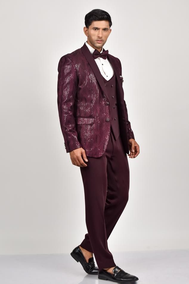 Wine shimmer tuxedo with sequin embroidery all over. Paired with a waistcoat, pant, shirt and bow tie.
Components: 5
Pattern: Embroidered
Type Of Work: Sequin
Neckline: Lapel collar
Sleeve Type: Long
Fabric: Crepe, Handloom Silk, Terry Rayon
Color: Wine
Other Details: 
Note: Pocket square worn by the model and outfit worn by the model on the left is not for sale.
Occasion: Cocktail and Reception - Aza Fashions Party Suits With Sequins, Sequin Party Suits For Party Season, Sequin Party Suits, Fitted Sequined Suits For Parties, Luxury Sequined Party Sets, Luxury Sequin Party Sets, Fitted Suit For Party And Gala, Elegant Formal Sets With Sequins, Elegant Formal Sequined Sets