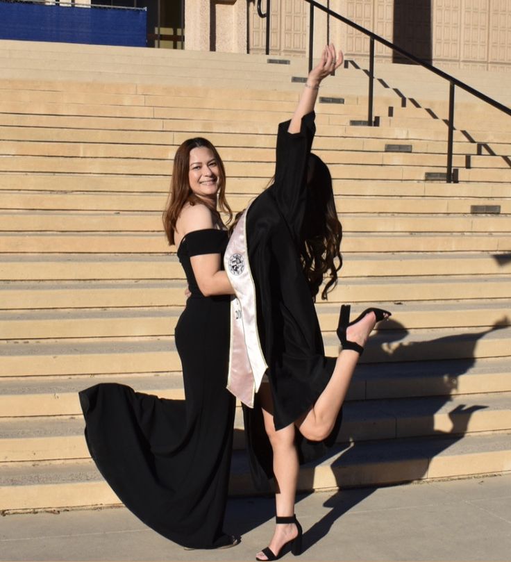 two young women are dancing on the steps