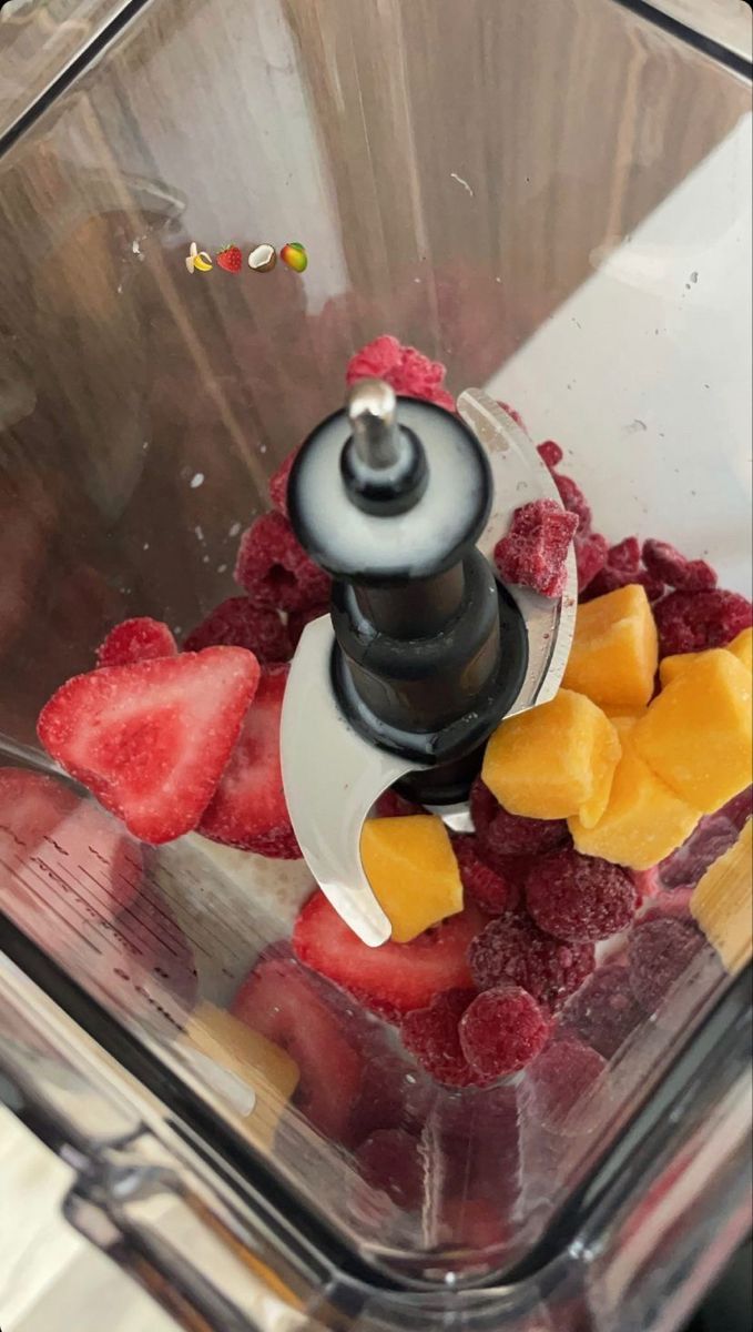 a blender filled with lots of fresh fruit