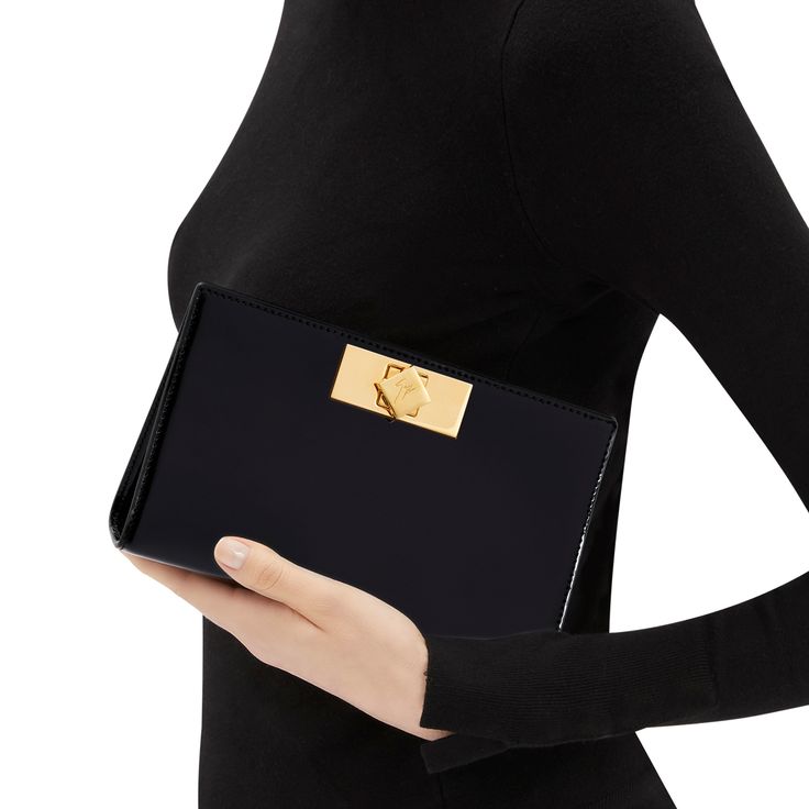 Patent leather clutch bag with central fastening, chain shoulder strap and inner card slots. Elegant Structured Clutch For Formal Occasions, Elegant Structured Formal Clutch, Designer Clutch For Formal Events, Designer Office Clutch With Magnetic Closure, Luxury Envelope Clutch For Formal Occasions, Designer Rectangular Clutch For Everyday Luxury, Designer Everyday Luxury Rectangular Clutch, Luxury Envelope Evening Bag For Formal Occasions, Luxury Office Clutch With Fold Over Clasp