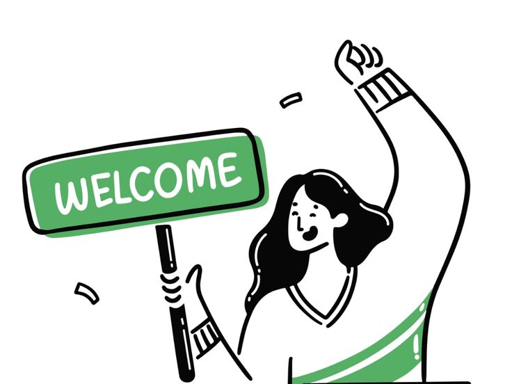 a woman holding a welcome sign with the word welcome in green and black on it