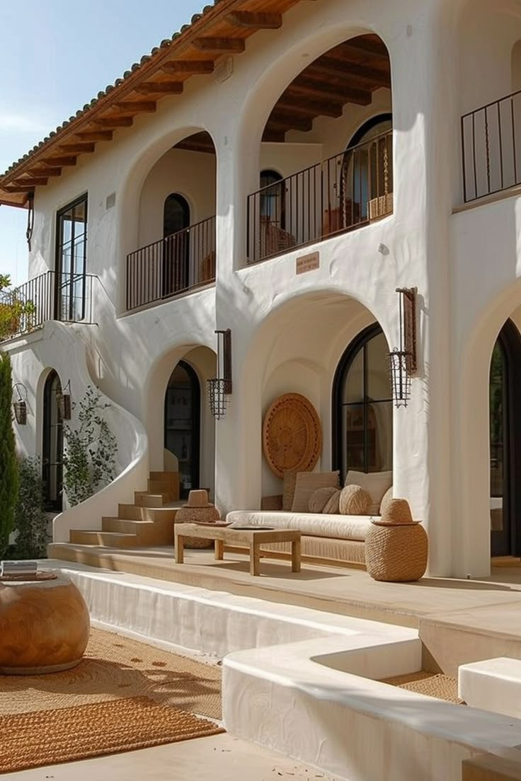 a large white building with lots of windows and steps leading up to the front door