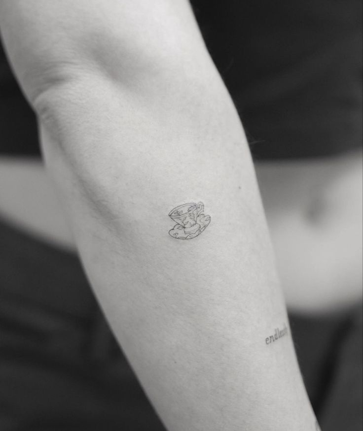 a person with a small tattoo on their arm