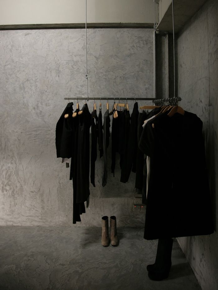 a room with clothes and shoes hanging on the rack