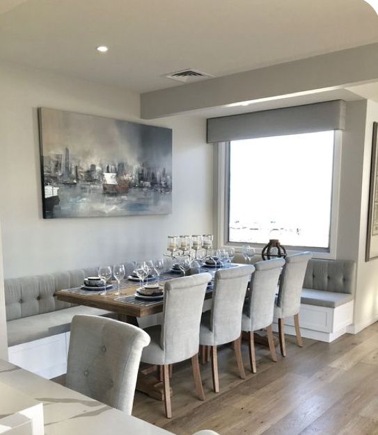 the dining room table is set with white chairs and place settings in front of a large window