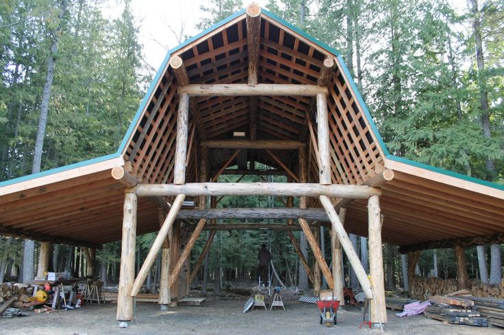 a large wooden structure sitting in the middle of a forest