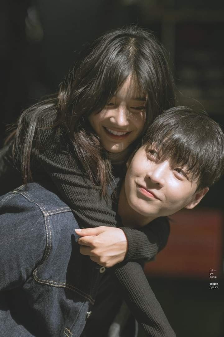 two people are hugging each other and smiling