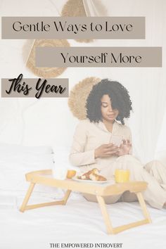 a woman is sitting on her bed while looking at her cell phone and eating breakfast