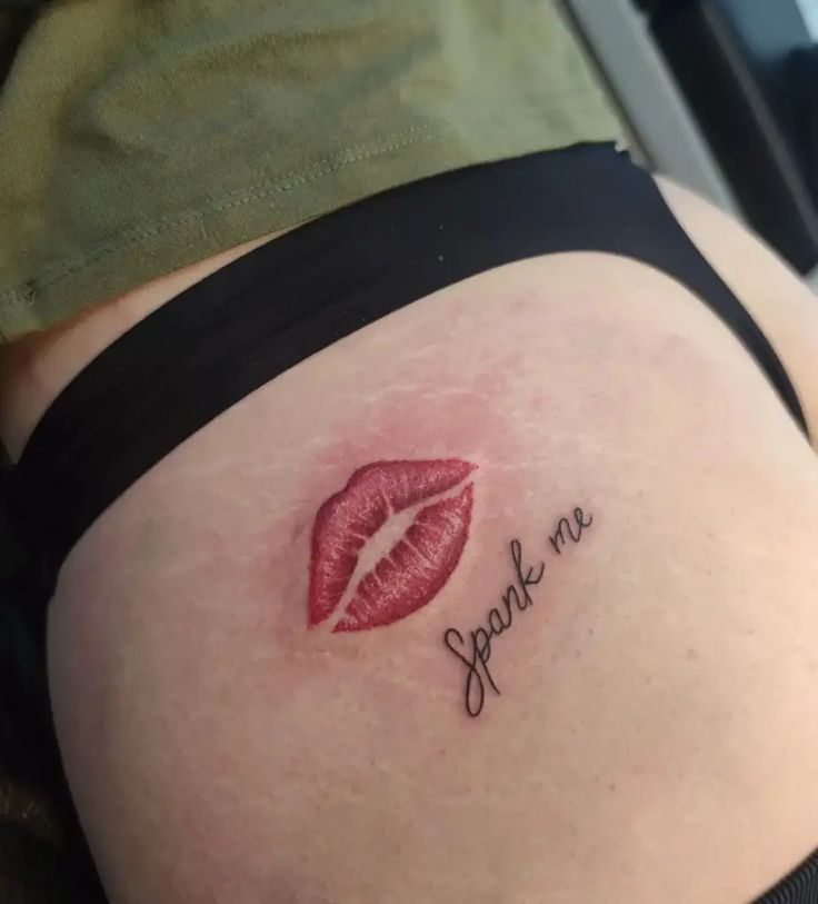 a woman's stomach with the word speak me written on it and a red lip