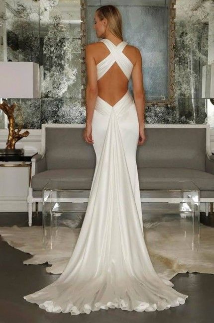 the back of a woman's wedding dress in front of a couch