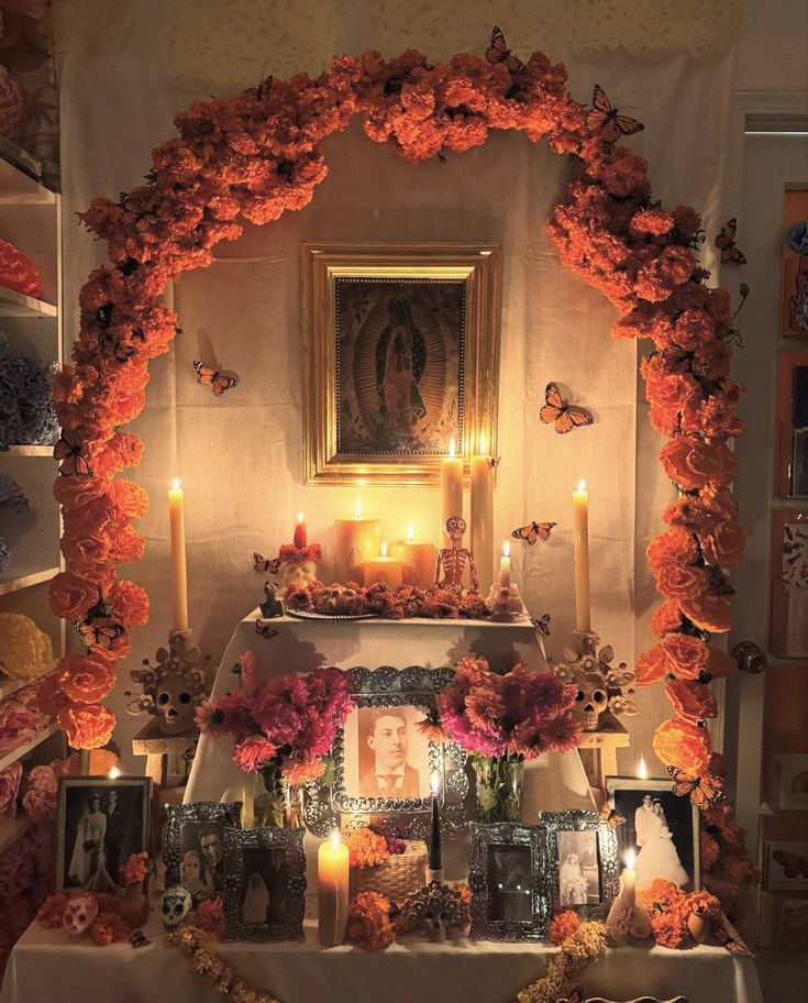 an altar with candles, flowers and pictures on the wall next to it is lit