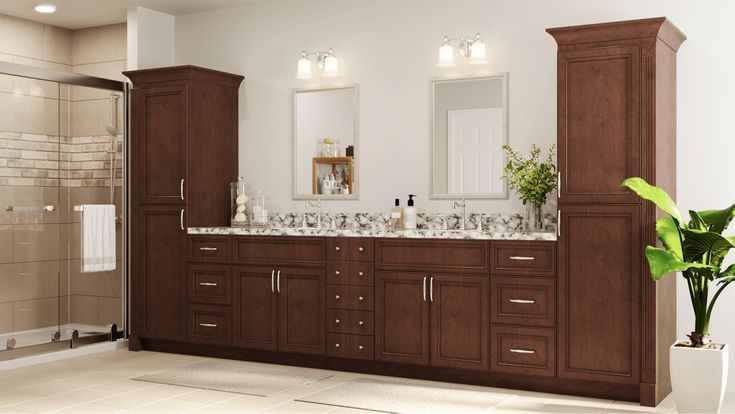 a bathroom with double sinks and brown cabinets