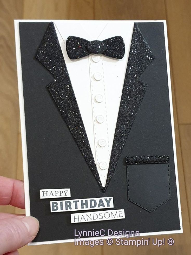 someone holding up a birthday card with a tuxedo on it