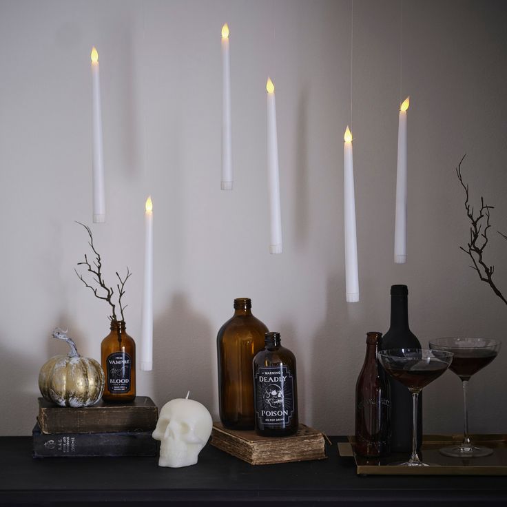 candles and bottles are arranged on a table