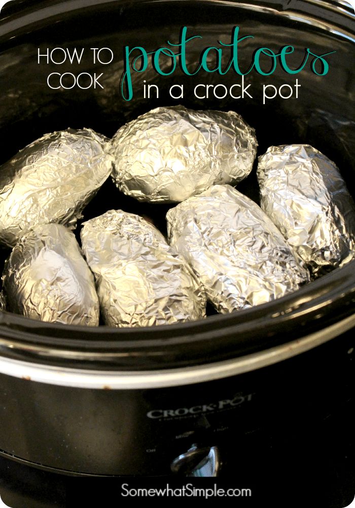 an crock pot filled with foil wrapped potatoes and text overlay that reads how to cook potatoes in a crock pot