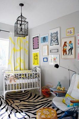 a baby's room with zebra print rug and yellow curtains