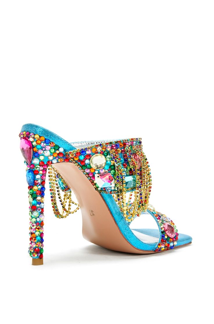 **FINAL SALE - NO EXCHANGES OR RETURNS** Our Envie stiletto mules are the perfect luxurious statement shoe. These feature an open toe and square cut silhouette made with a blue fabrication and colorful rhinestone embellishments all over the shoe. The front strap also includes gold chain accents draping down the shoe. These beautiful shoes would be perfect styled for a going out look! Heel Height: 4.75" Stained Glass Shoes, Thick Heeled Shoes, Shoe Goals, Glass Shoes, Fashion Words, Jeweled Shoes, Shoes Heels Classy, Chain Dress, Azalea Wang