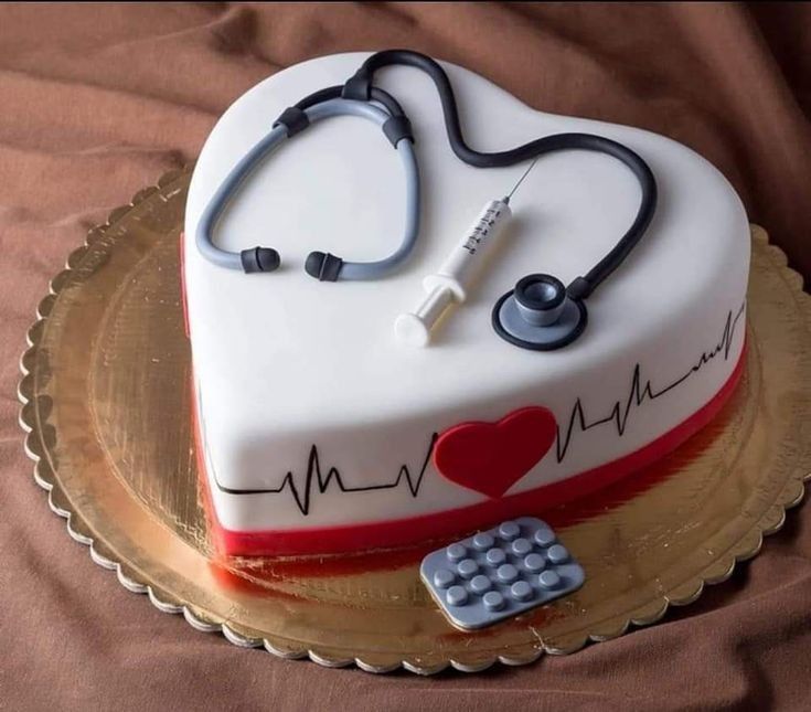 a heart - shaped cake with a stethoscope on it and a calculator