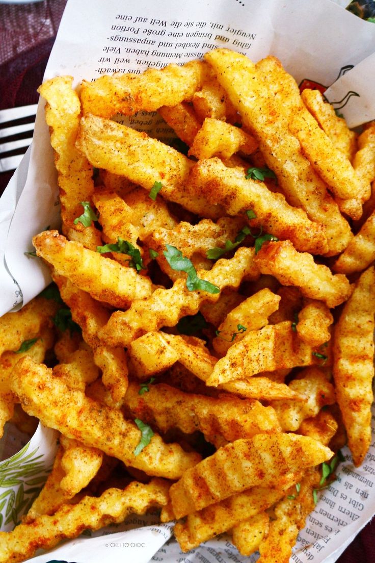 french fries are in a basket on a table