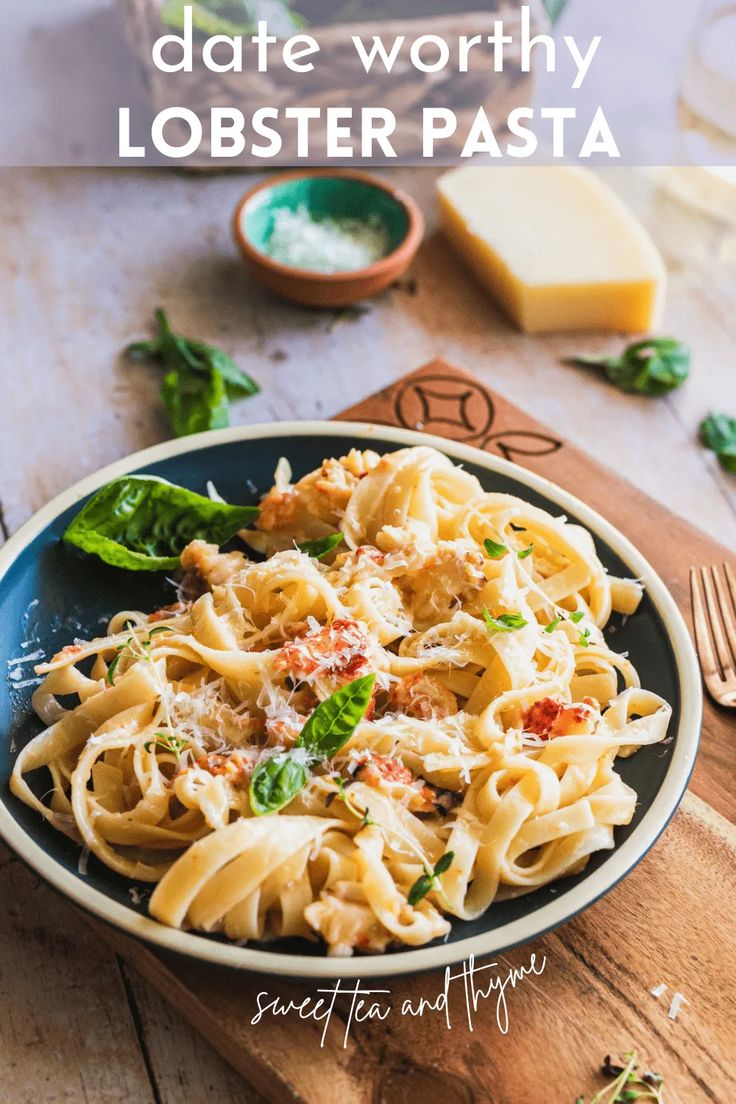 a plate of pasta with cheese and spinach on the side, next to a knife and fork