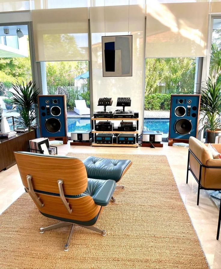 a living room filled with furniture and speakers