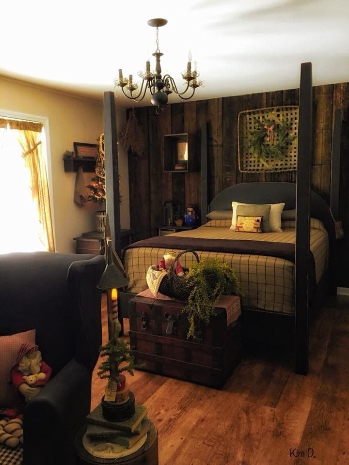 a bed room with a neatly made bed and wooden floors