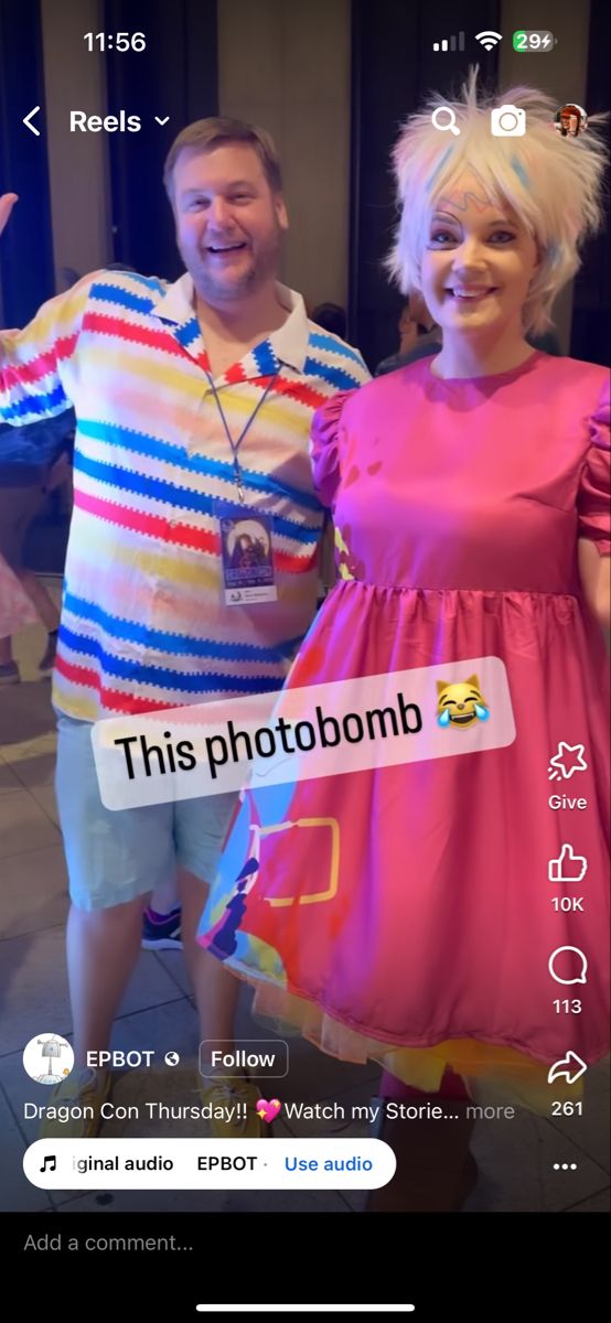 two people dressed up in costumes standing next to each other and one person is holding a cell phone