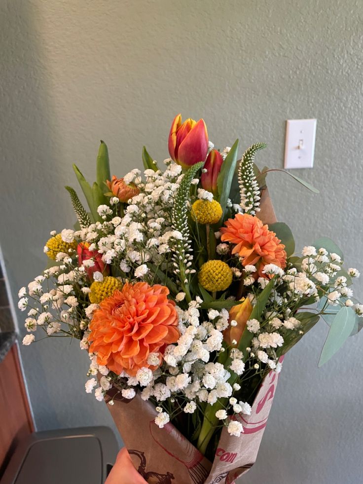 a bouquet of flowers sitting on top of a table