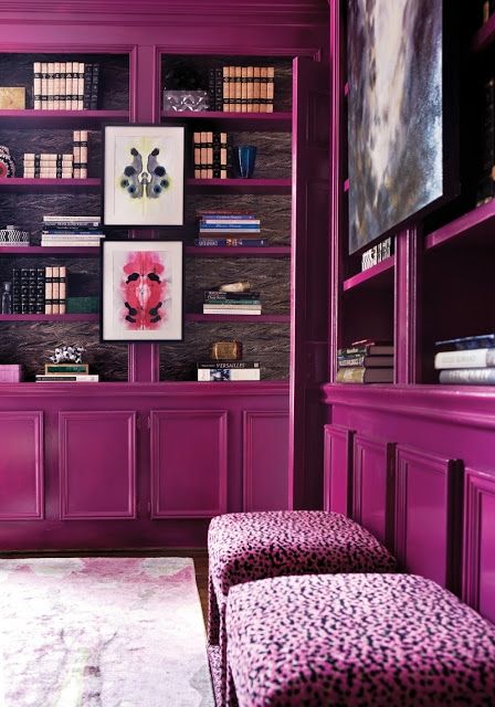 a living room with purple furniture and pictures on the wall