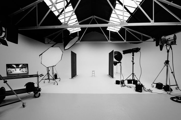 black and white photograph of lighting equipment in an empty room with skylights on the ceiling