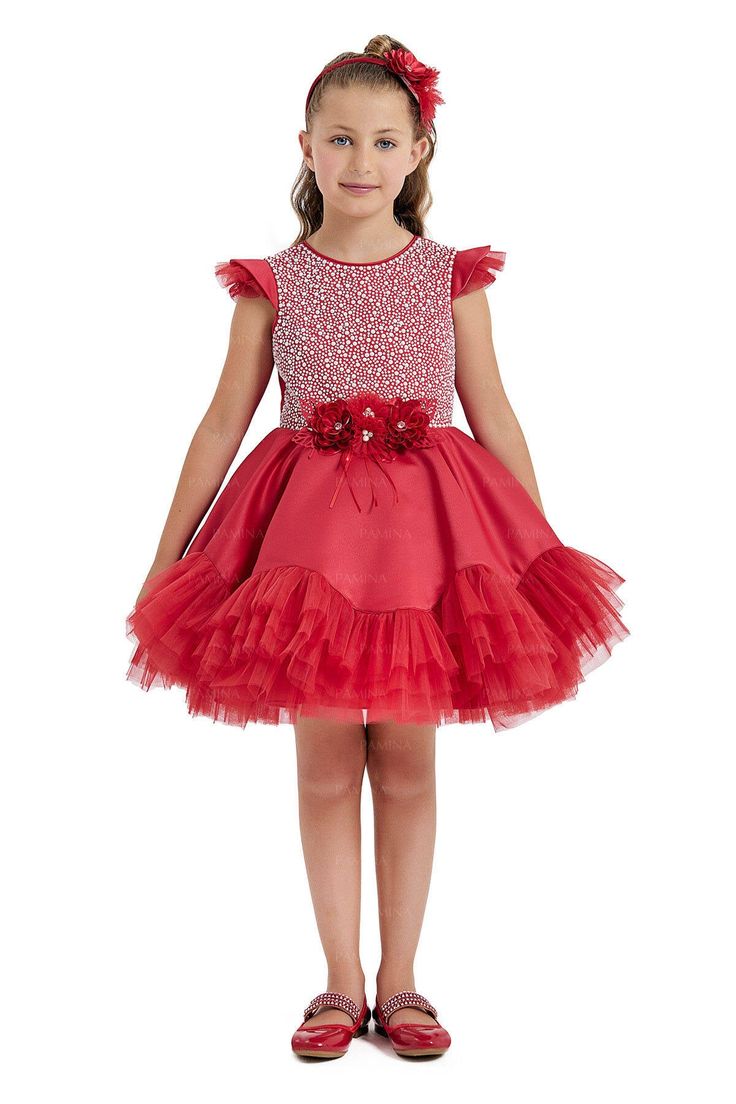 This charming Girls Red Christmas Dress is an eye-catching piece for the festive season. It features a bodice adorned with delightful faux pearls and sequins that mimic a snowfall on a winter's day, perfect for capturing the magic of the holidays. The shoulders are sweetly accented with soft ruffles. At the waist, there's an intricate gathering of red flowers centered with sparkling beads. A full, layered tulle skirt with a frilly hem is made for twirling at holiday parties. The tulle overlay gi Holiday Princess Dress For Fancy Dress, Holiday Princess Dress With Tulle, Holiday Tulle Dress With Ruffles, Princess Tulle Holiday Dress For Christmas, Princess Style Tulle Holiday Dress For Christmas, Festive Red Princess Dress For Dress-up, Christmas Tulle Holiday Dress With Ruffles, Fitted Tutu Dress For Christmas Fancy Dress, Fitted Christmas Tutu Dress For Fancy Dress