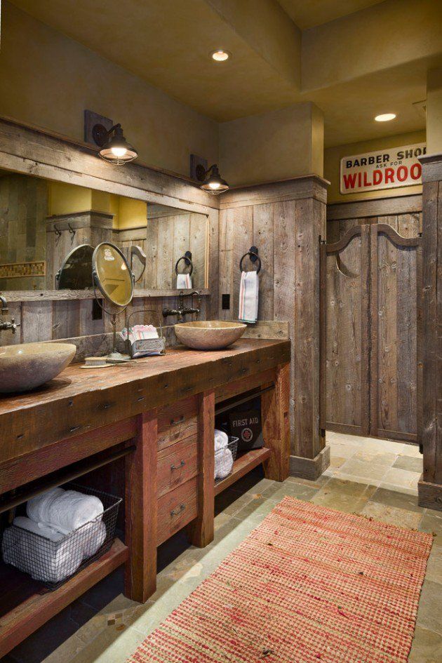 a rustic bathroom with two sinks and wooden cabinets