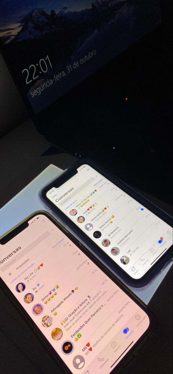 two iphones sitting next to each other on a table