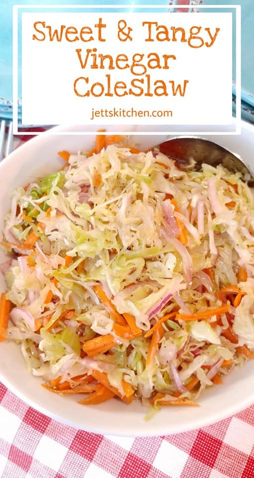 a white bowl filled with coleslaw sitting on top of a red and white checkered table cloth