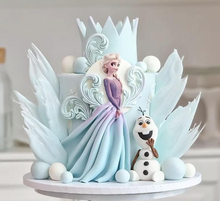 a frozen princess cake with frosting and decorations