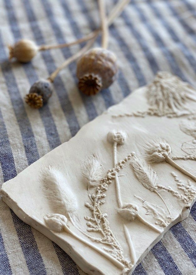 a piece of clay sitting on top of a blue and white table cloth