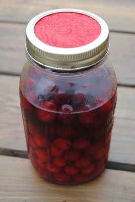 a jar filled with liquid sitting on top of a wooden table