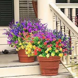 two flower pots with colorful flowers on the steps