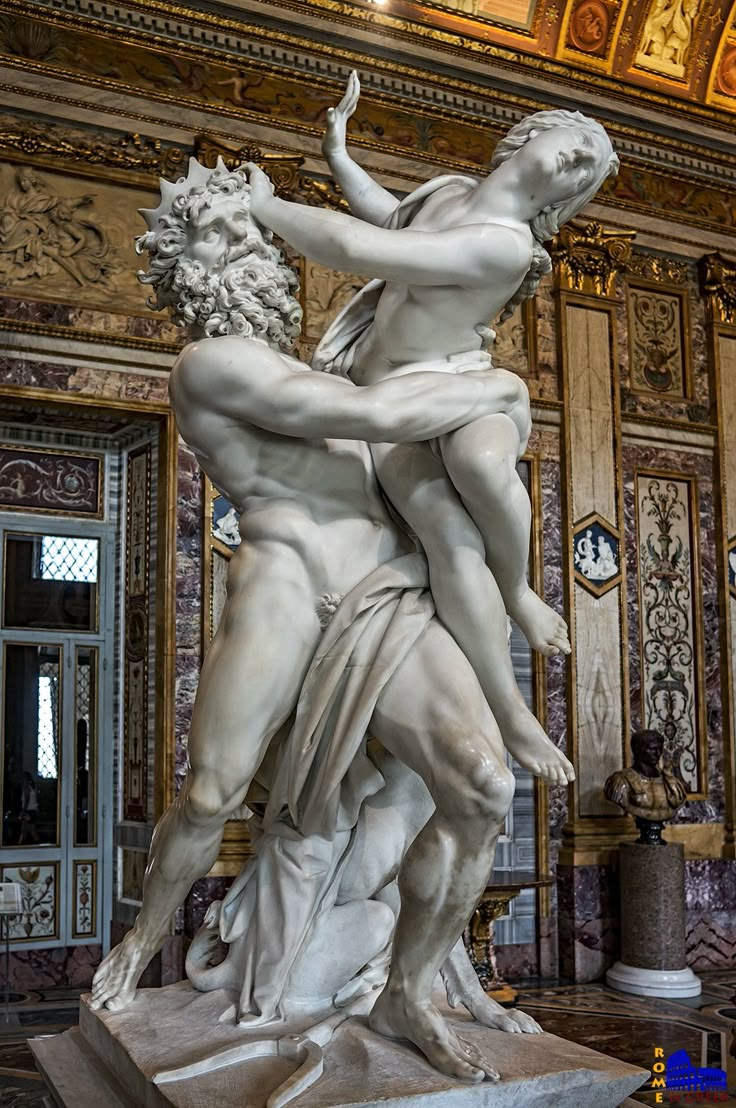 the statue is surrounded by other statues in an ornate room with gold and white walls