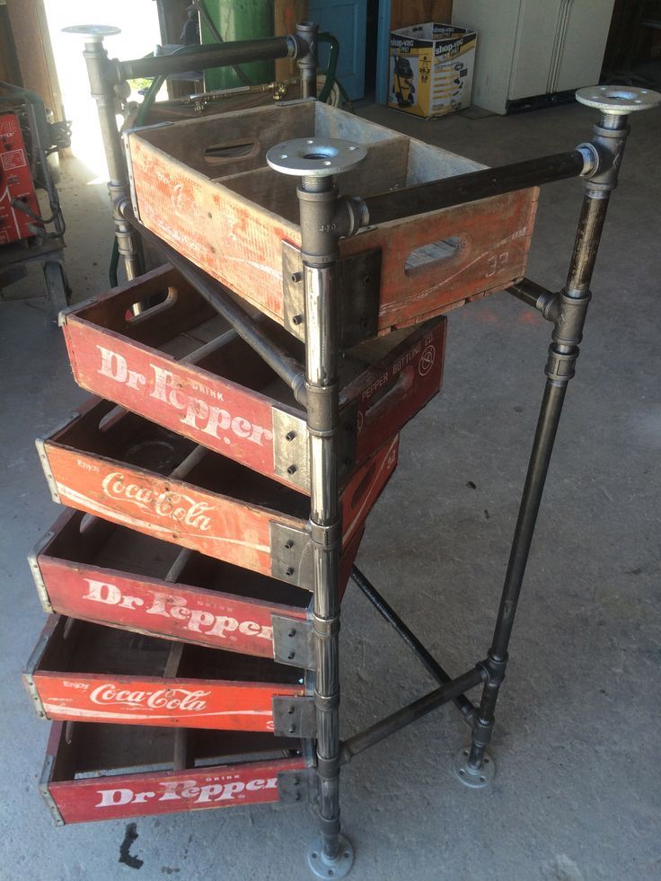 an old metal cart with lots of wooden boxes on it