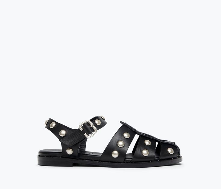 A tougher fisherman sandal. Handcrafted with our signature black calf, the SERA is classic with the caged upper and padded footbed but reimagined this season with cool understated studs. This style has a roomier fit. If you’re in between sizes or have a narrow foot, take a 1/2 size down. 100% Italian leather in black calf Padded leather footbed Studded welt leather sole with rubber layer for enhanced durability Adjustable strap with custom buckle Custom stud detail across upper leather Luxury Fisherman Sandals For Spring, Affordable Open Toe Fisherman Sandals For Vacation, Luxury Closed Toe Classic Fisherman Sandals, Luxury Open Toe Fisherman Sandals, Luxury Open Toe Fisherman Sandals For Formal Occasions, Luxury Fisherman Sandals With Removable Insole, Luxury Black Open Heel Fisherman Sandals, Luxury Black Fisherman Sandals With Open Heel, Luxury Black Fisherman Sandals Open Heel