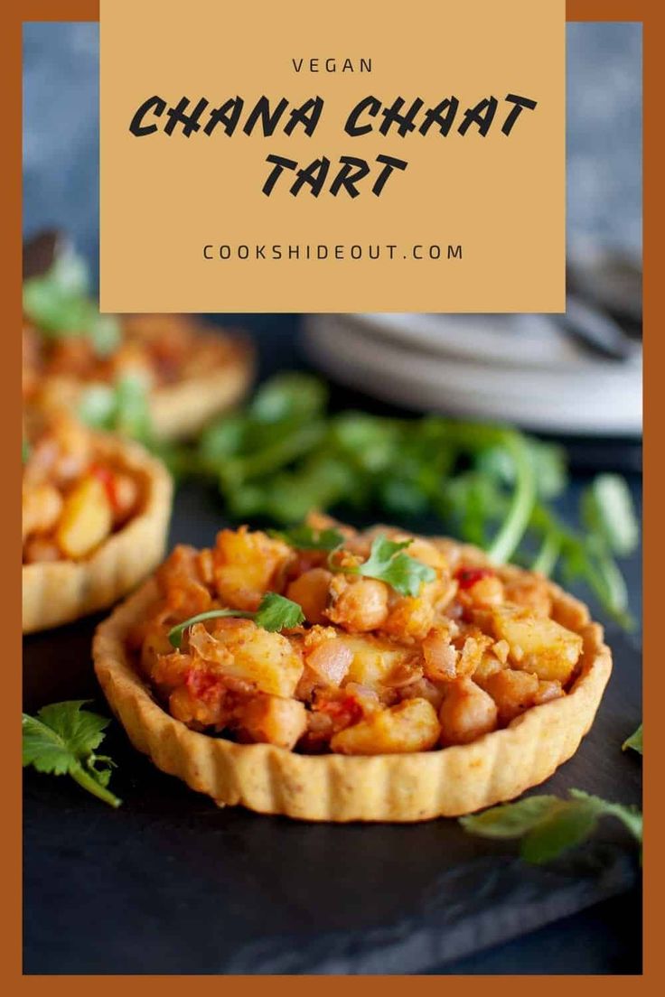 vegan chana chaat tart on a black plate with green garnish