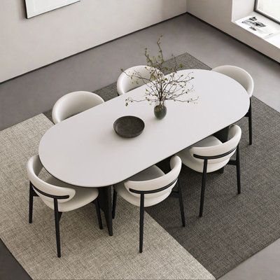 a white table with four chairs around it