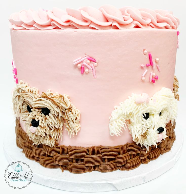 a pink cake with two dogs on it