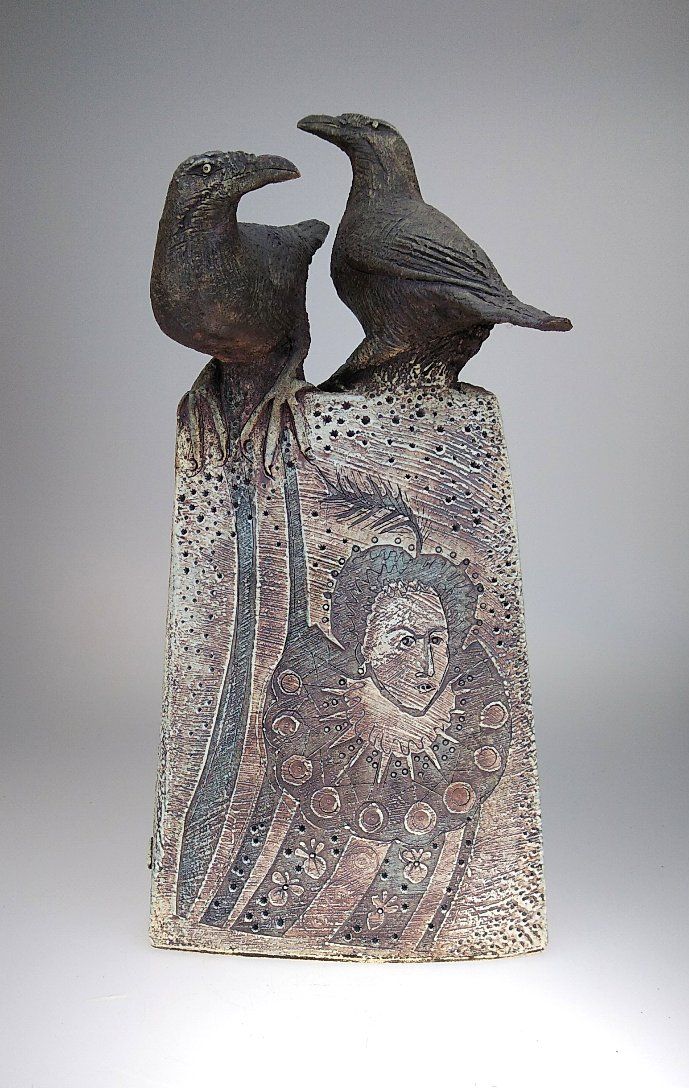 two birds sitting on top of a vase