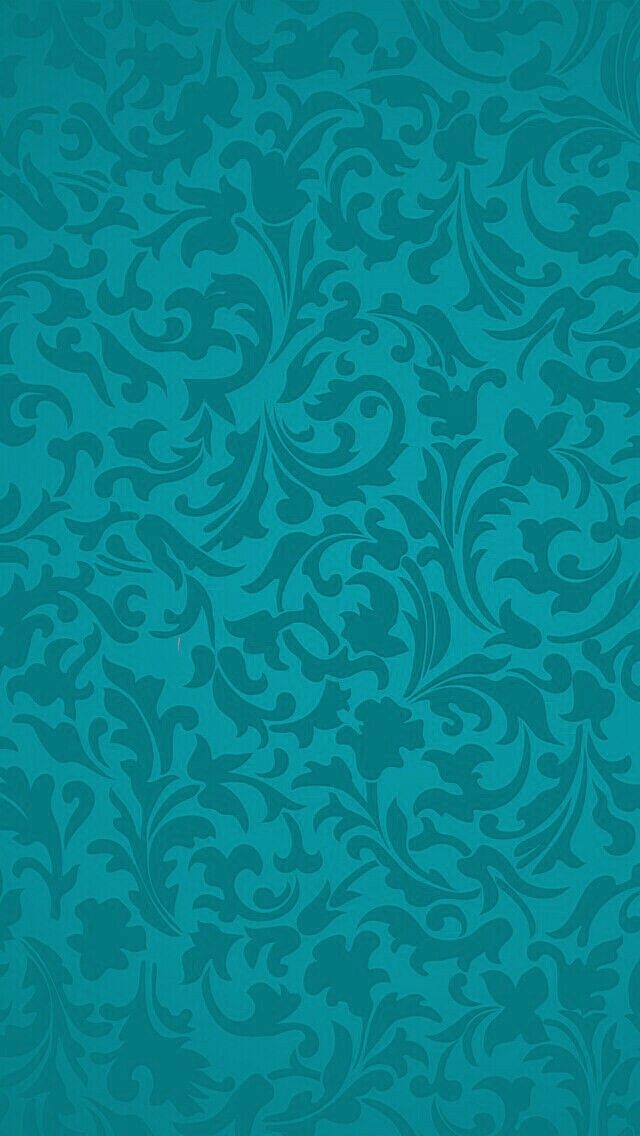 a blue wallpaper with an ornate design on it's side, in the middle of