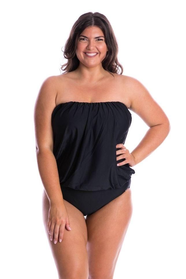 Black Flouncy Strapless One Piece Hit the beach with confidence in the Black Flouncy Bandeau one piece. This strapless black one piece offers versatility, comfort and style for every woman. This fabulous swimsuit helps to balance out your proportions, making it an ideal choice for pear shapes or those with a smaller bust. Feel comfortable and confident in this sophisticated blouson one piece style. Removable Straps Adjustable Straps Shelf Bra Fabric: 82% Nylon 18% Spandex UPF 50+ Models wear size 16 Black Bandeau Tankini For Summer, Black Bandeau Swimwear For Swimming, Black Bandeau Swimwear For Pool, Black Bandeau Tankini For Beach Season, Black Bandeau Tankini For Swimming, Black Bandeau Tankini For Sunbathing, Solid Color Strapless Swimwear For Vacation, Strapless Black Swimwear For Beach Season, Strapless Solid Color Tankini For Beach Season