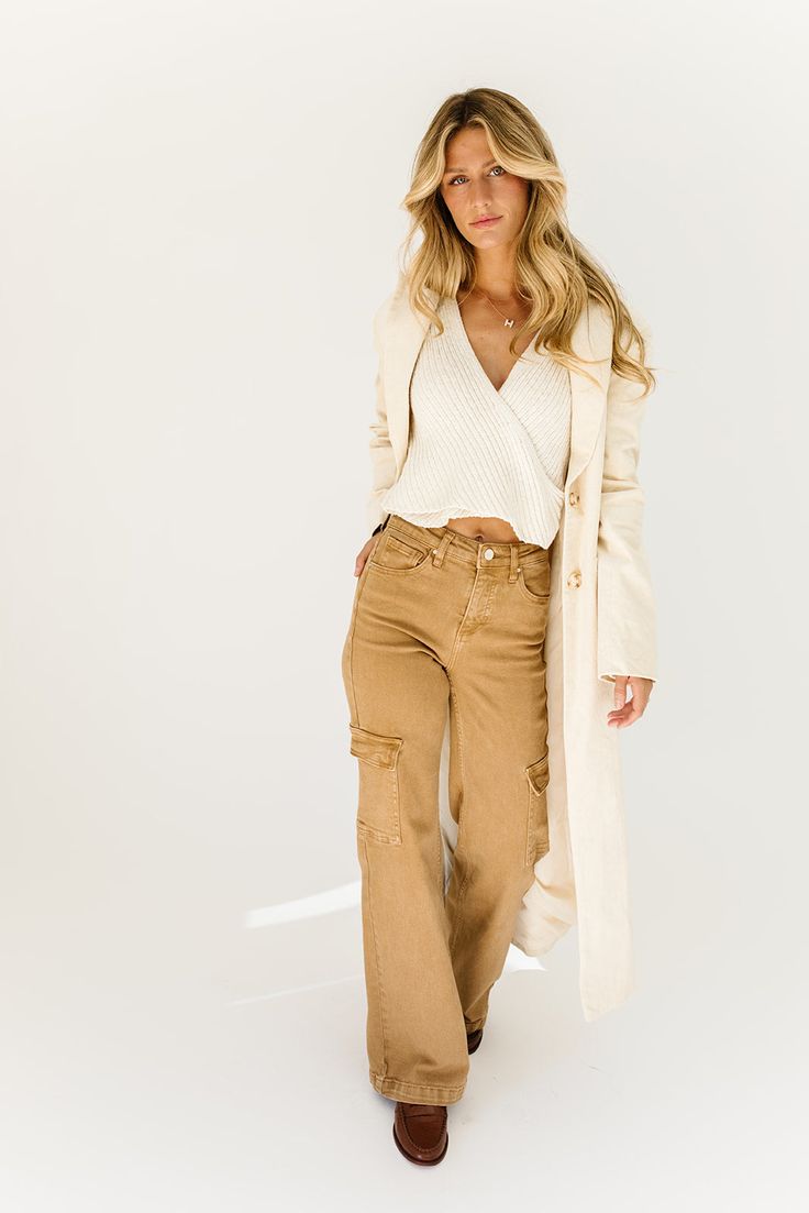 a fresh take on the oversized blazer, this cream trench coat is a must-have for business casual baddies. it has a relaxed longline silhouette, luxe working buttons, + is made with a thick cotton material (so it will actually keep you warm). the perfect spring // winter coat to elevate your casual fits or embellish your formal ones. natural // lapel collar, buttons, pockets, cuffed sleeves, corduroy paired with our charlotte wrap top + kenny cargo pants + hardi slingback penny loafers model is 5' Chic Long Cotton Coat, Chic Cream Cotton Outerwear, Chic Cotton Blazer For Day Out, Chic Neutral Cotton Outerwear, Fall Cotton Blazer For Day Out, Fall Day Out Cotton Blazer, Cotton Blazer For Fall Day Out, Chic Everyday Outerwear With Notch Lapel, Chic Notch Lapel Outerwear For Everyday