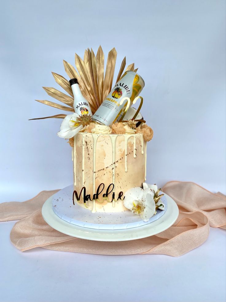 a cake decorated with champagne and flowers on a plate