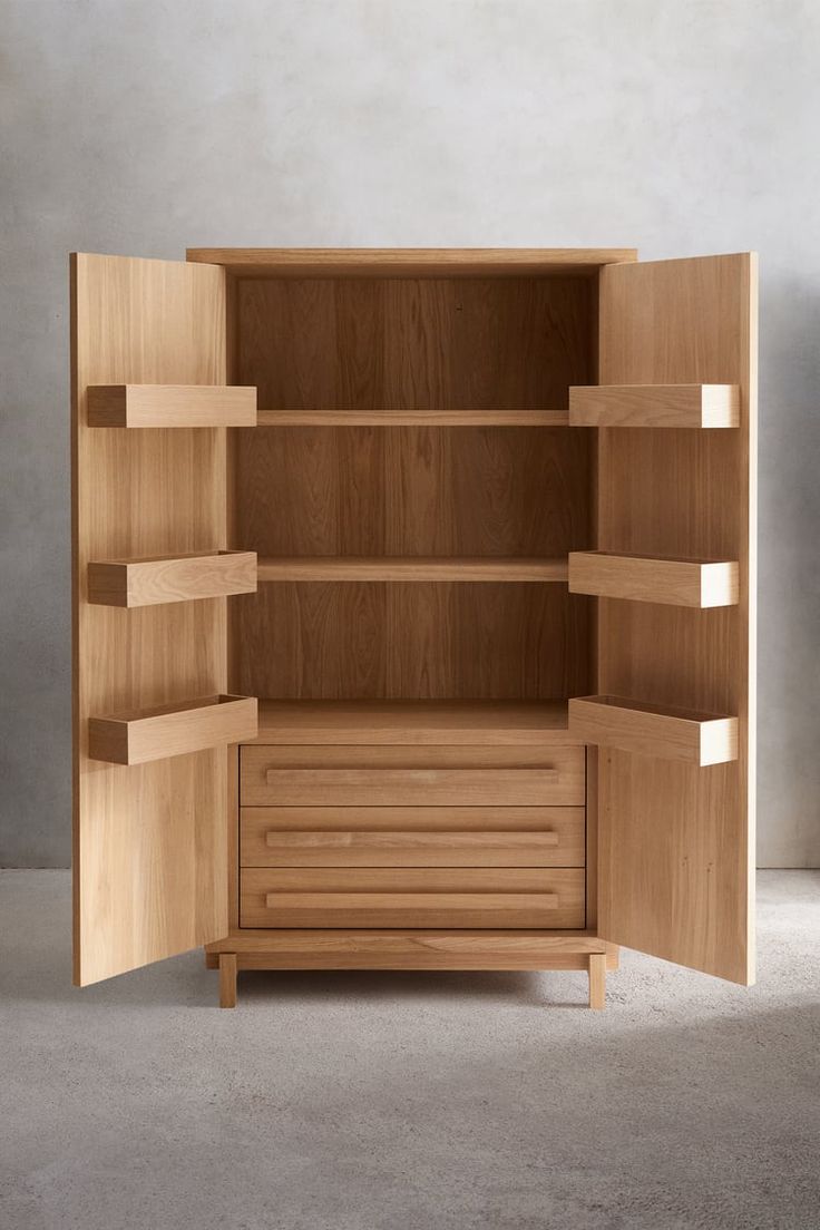 an open wooden cabinet with shelves and drawers